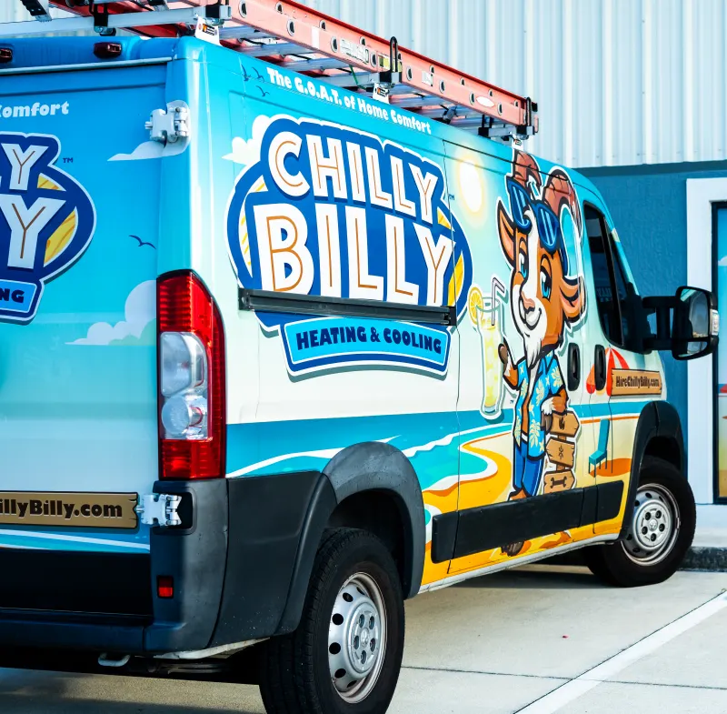 Chilly Billy Heating & Cooling's wrapped service van with Billy the goat mascot parked outside the company shop in Kissimmee