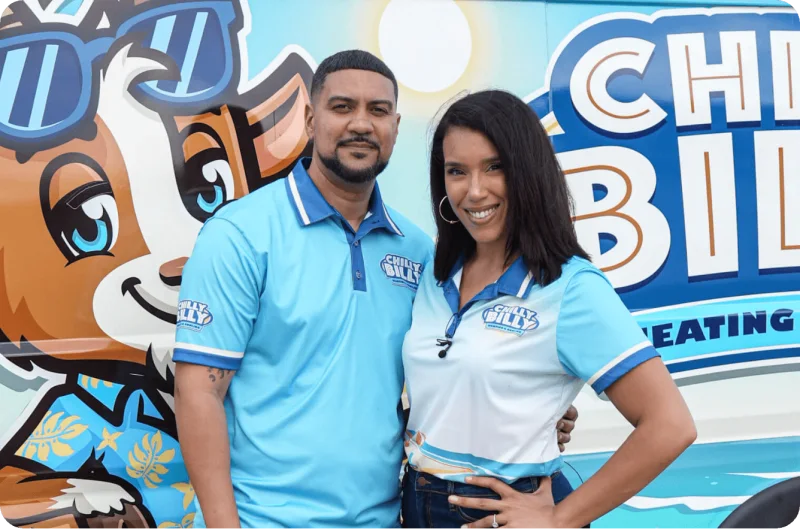 Chilly Billy co-owners Taisha and Chris Javier in company polos in front of their wrapped service van