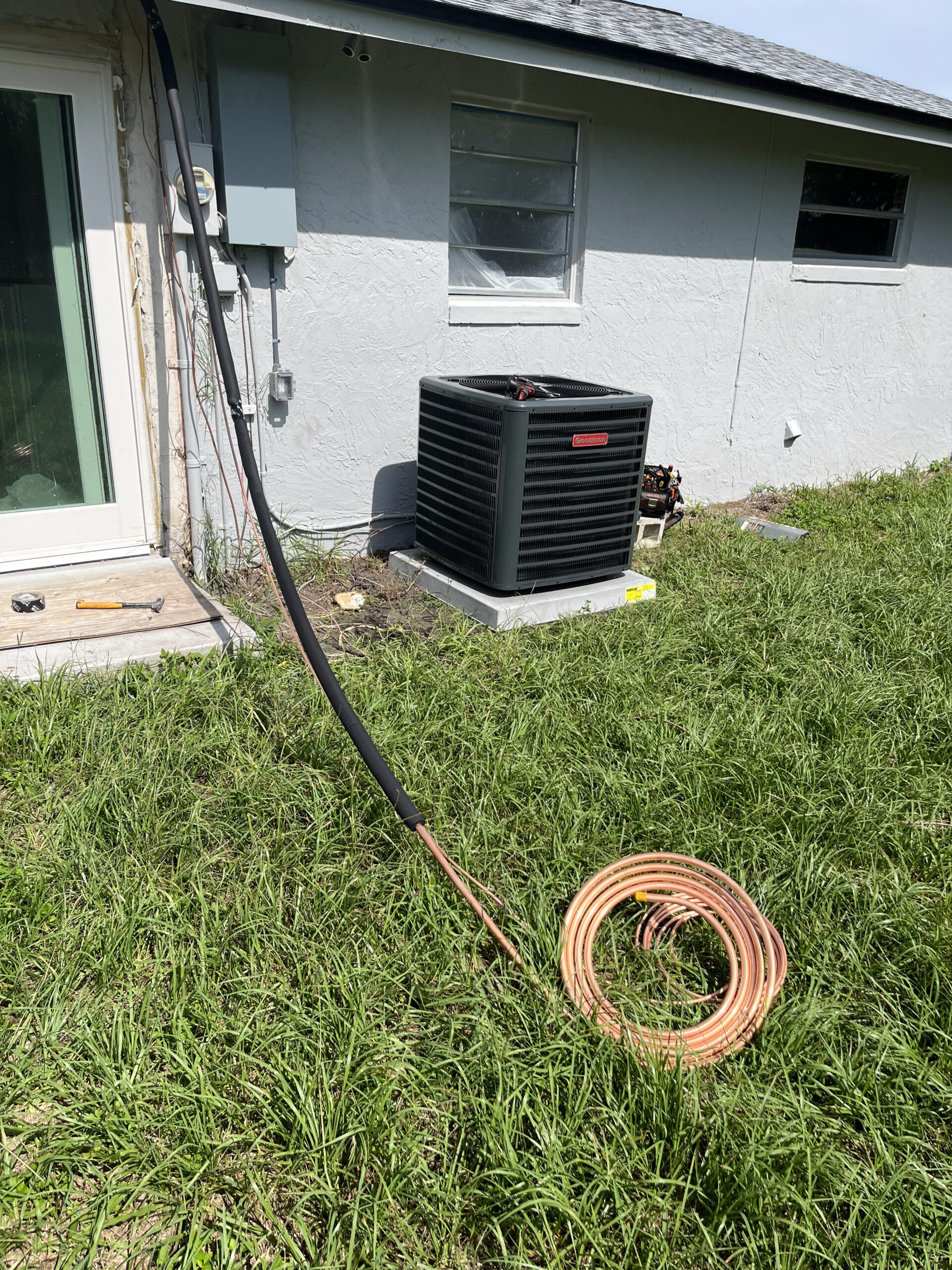 Homeowner discussing AC maintenance concerns with a technician inside a US home